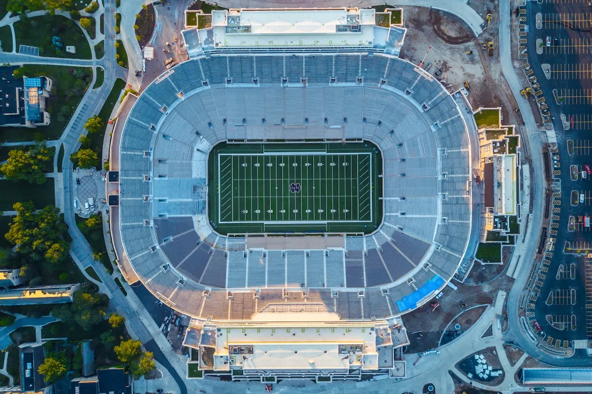 Aerial view of a large college football stadium surrounded by campus buildings